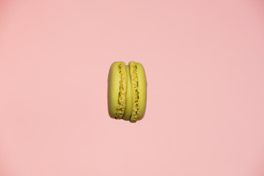 Pistachio sweet meringue-based confection known as macaron, or French macarron isolated on a pastel background