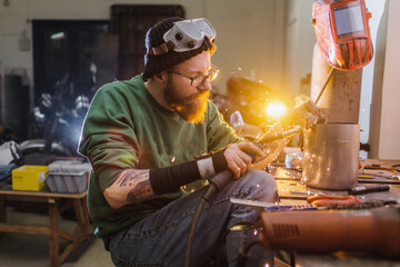 Men build a motorcycle