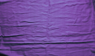 Violet textured vibrant cloth with folds. Abstract backdrop. Wallpaper. Mock up.