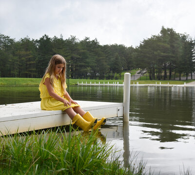 Gilr Sitting Alone in Nature Outside by Water Dock