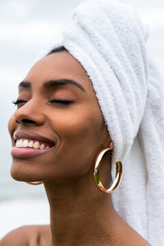 Cheerful black lady with towel on head