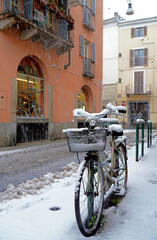 Bicycle parked during the snowfall