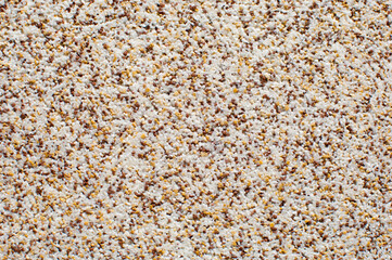 Stone wall made of gravels of white, gray, black and red colors