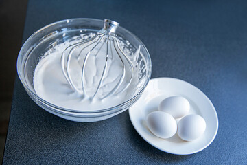 A bowl of whipped whites on the table