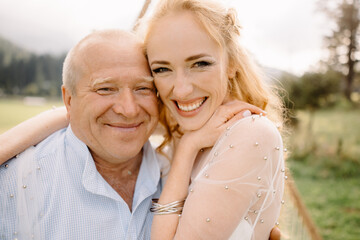 daughter hugs her elderly father