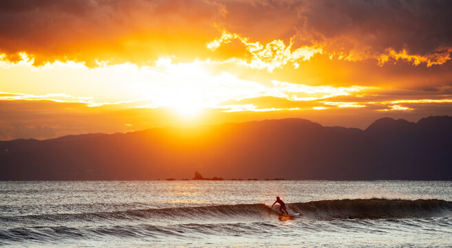 Surfing in Mellow Atmosphere at Sunset Time
