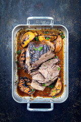 Traditional braised Greek lamb roast with quinces in brown sauce served as top view in a casserole © HLPhoto