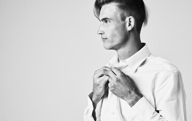 portrait of a young man in a shirt on a light background Gentleman suit