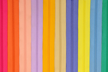 Texture of colourful zippers together for sewing, flat lay