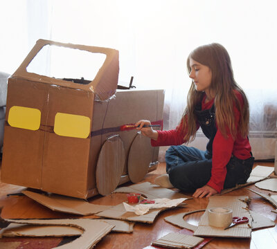 Creative Child Making Cardboard Car at Home
