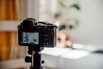 Professional camera recording video of woman practicing yoga