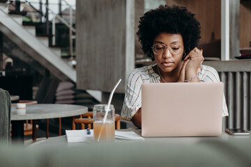Pensive woman working in a stylish interior
