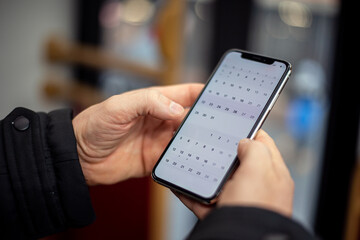 Crop man using smartphone in public transport