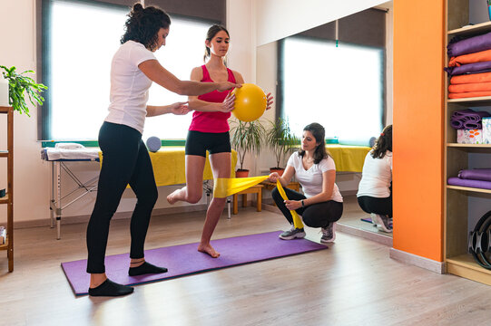 Female instructors and patient during physiotherapy session