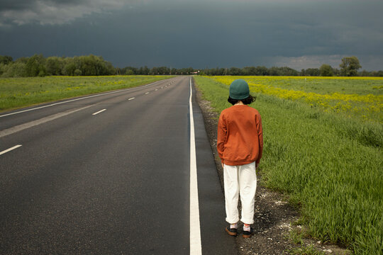 Preteen girl stands a road