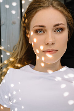 portrait of young woman looking at camera in circle shaped sun rays