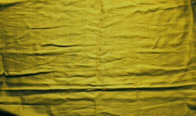 Golden textured vibrant cloth with folds. Abstract backdrop. Wallpaper. Mock up.