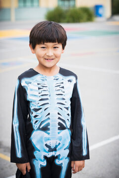 Portrait of Hispanic boy smiling in skeleton costume