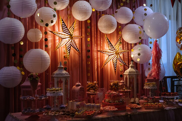 Lamps in the shape of a stars in photo zone decoration. Christmas ornament.