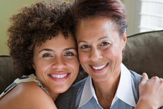 Mixed race mother and daughter hugging