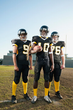 Football players standing on football field