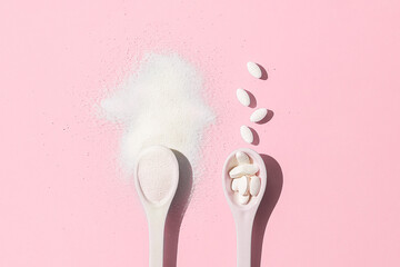 Collagen spoons on a pink background. Top view.