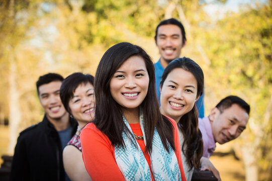 Chinese family smiling outdoors