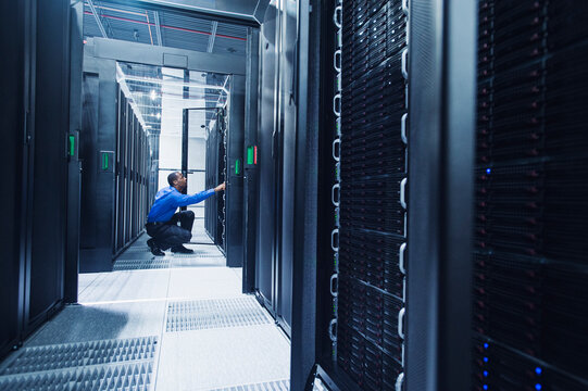 Black businessman working in server room