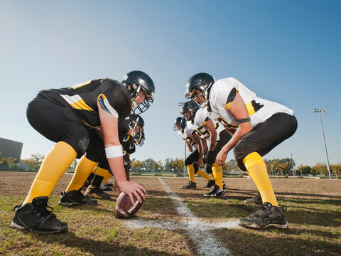 Football players crouching on football field