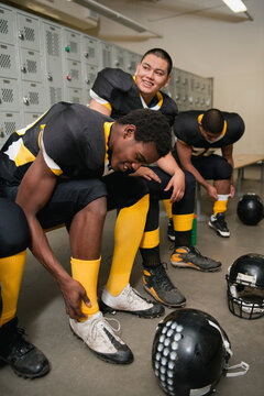 Football players dressing in locker room