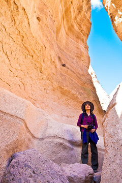 Japanese woman exploring rock formations, Santa Fe, New Mexico, United States
