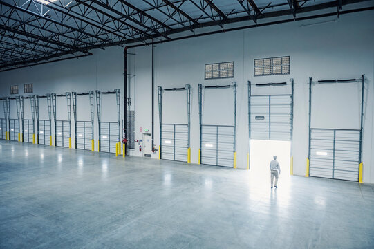 Caucasian businessman walking near open door on loading dock