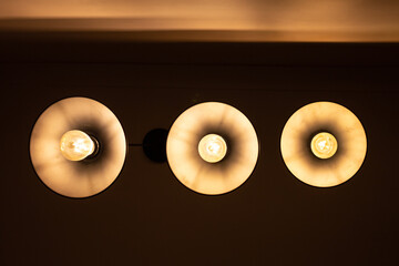 Three round lamps on the ceiling, bottom view