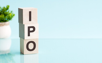three wooden cubes with letters IPO - short for initial public offering, concept
