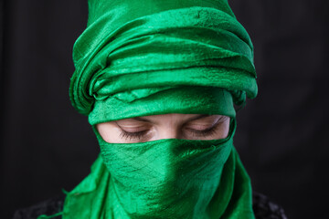 Beautiful muslim woman dressed in green headscarf