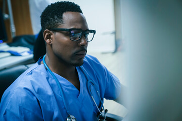 Black nurse using computer