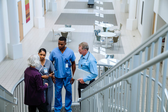 Doctors and nurses talking on staircase