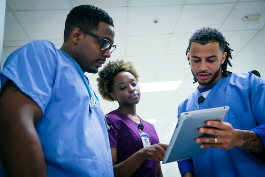 Nurses discussing digital tablet