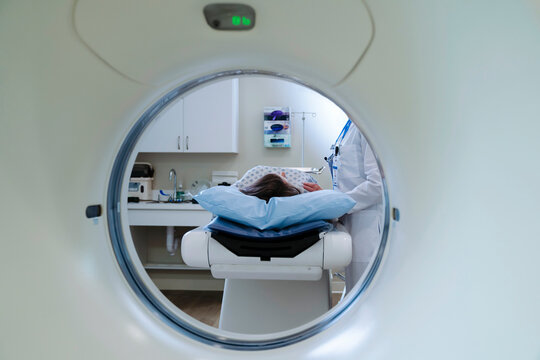 Caucasian doctor comforting patient near scanner