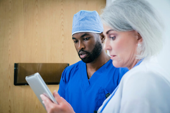 Doctor and nurse discussing digital tablet