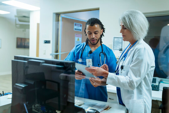 Doctor and nurse discussing digital tablet