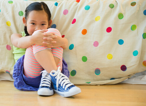Korean girl sitting on bedroom floor