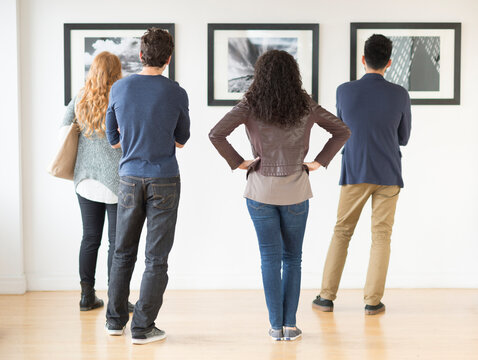 Couples admiring art in gallery