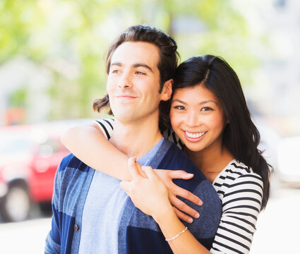 Couple hugging on urban street