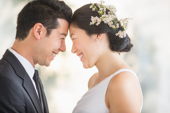 Newlywed couple smiling face to face