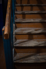 Fototapeta na wymiar Old wooden staircase in a dark entrance