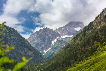 Beautiful mountain landscape with forest and clouds at Caucasus mountains.