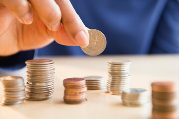 Mixed race woman stacking coins