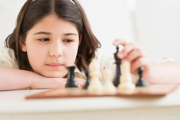 Hispanic girl playing chess