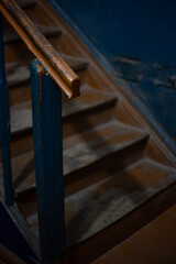 Old wooden staircase in a dark entrance